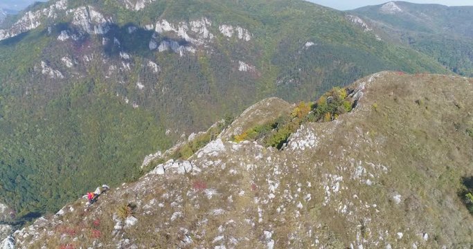 Aerial view of man hiking on the edge of mountain - Transylvania