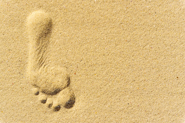 Copy space with footprint on sand beach. Travel concept.