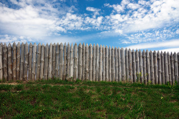 Fototapeta na wymiar garden fence on the background of blue sky