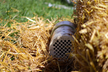 Training tube for barn hunting used for dogs hunting rats surrounded by loose hay