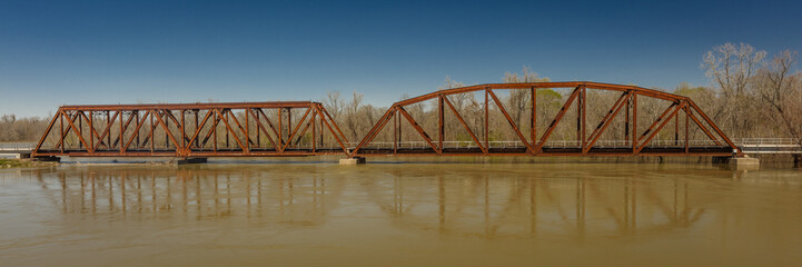 Fototapeta na wymiar Iron Railroad Bridge over water, Texas