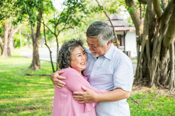 Fototapeta premium Senior couple in park. Dancing together, relaxing and loving each other with a smile