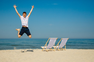 Young man jumping on beach