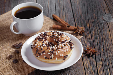 Donut with chocolate balls and coffee
