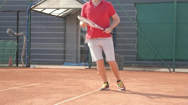 A Man does exercises jumping before playing Tennis on a Cort