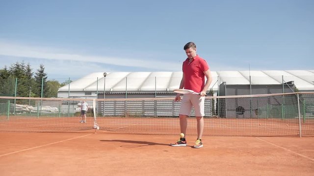 Man Tennis Player having fun on a Cort after the Game Set