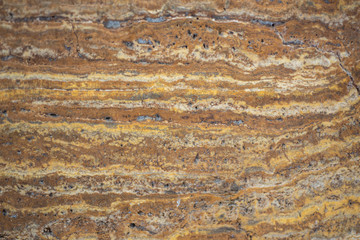 Beautiful Tiger yellow - orange -brown granite thumb vein cut background texture, close up.
