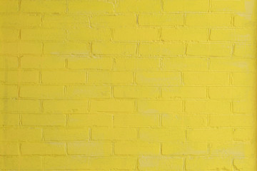 Obraz premium Yellow painted brick wall as a background or backdrop