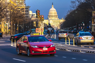 APRIL 11, 2018 WASHINGTON D.C. - Red car down Pennsylvania Ave to US Capitol going towards US Capitol in Washington DC. during rush hour PM