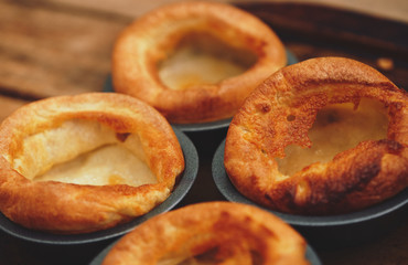 Freshly cooked Yorkshire Puddings for a Sunday roast dinner. British, English cuisine.