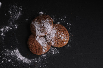 oatmeal cookies on a black table in castor sugar