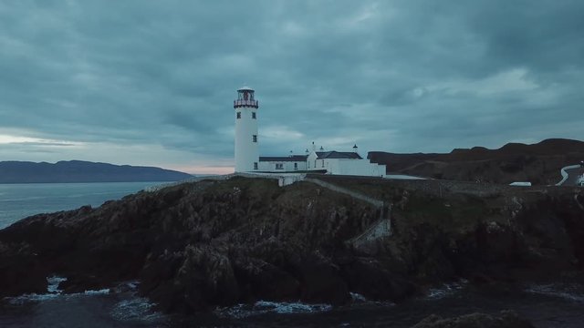 aerial footage of beautiful lighthouse on a cliff in Fanad, Ireland