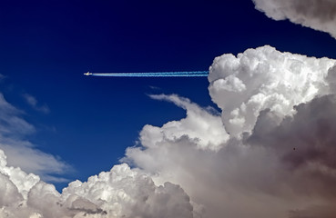 Jet airliner emerging from behind a cloud