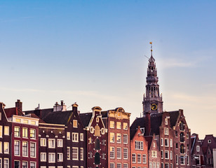 View of colorful Amsterdam houses and the tower of Westerkerk church during sunset