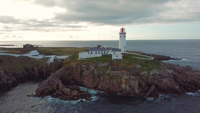 aerial footage of beautiful lighthouse on a cliff in Fanad, Ireland