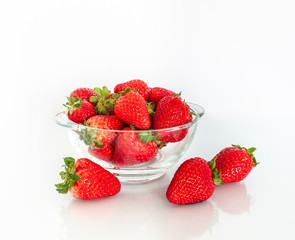 Fresh strawberries in a glass bowl isolated on a white background. Weight loss diet or healthy eating.
