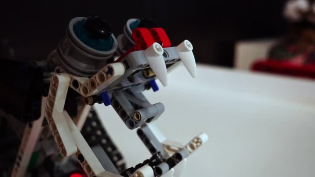 Homemade robot from the constructor opens mouth and shows teeth