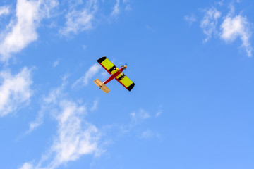 Homemade radio control aircraft on blue sky.