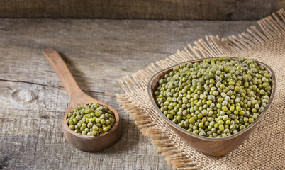 Raw mung beans. Wood background - Vigna radiata