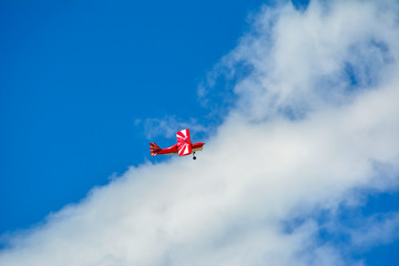 Homemade radio control aircraft on blue sky.