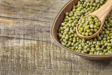 Raw mung beans. Wood background - Vigna radiata