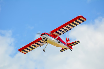 Homemade radio control aircraft on blue sky.