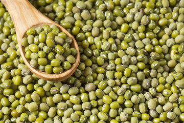 Raw mung beans. Wood background - Vigna radiata