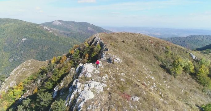 Aerial view of man hiking on the edge of mountain - Transylvania