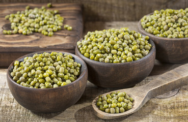 Raw mung beans. Wood background - Vigna radiata