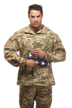 US Soldier holding folded flag