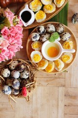 Grilled eggs with sauce on wood background