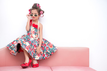 Young super model girl portrait. Pre teen girl dress up like a super model portrait. High heel red shoes, white sunglasses. Confident pose.
