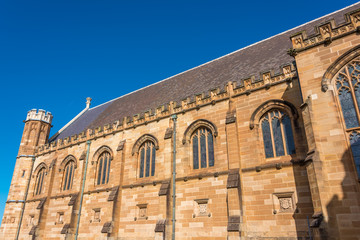 Sandstone gothic building with arch windows and decorations