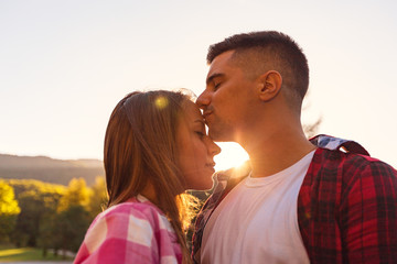 Man kissing a woman's forehead