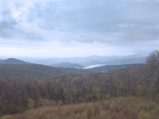 Fototapeta na wymiar Fog in valley with gray clouds