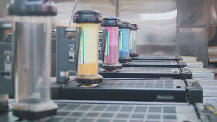 Containers with paints for printing press in the typography