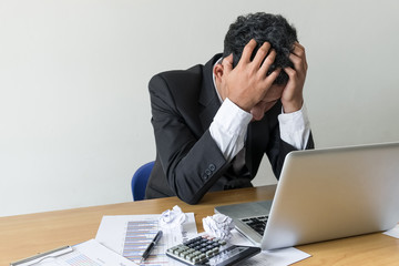 Young businessman stressed jobs,headaches about the job on table,vintage style.