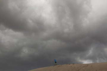 Fototapeta premium Rain clouds over sand dunes