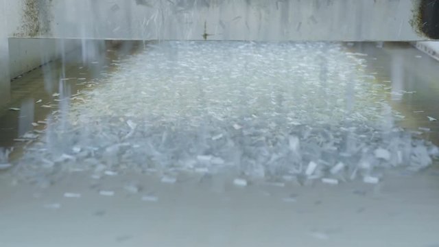 plastic material for synthatic threads falls to conveyor