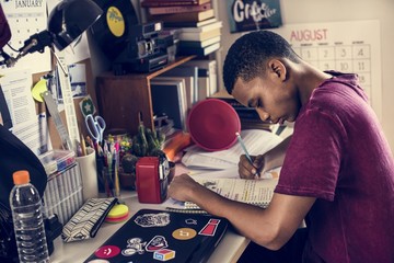 Teenage boy in a bedroom doing work stressed out and frustrated - obrazy, fototapety, plakaty