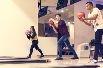 Friends playing bowling together