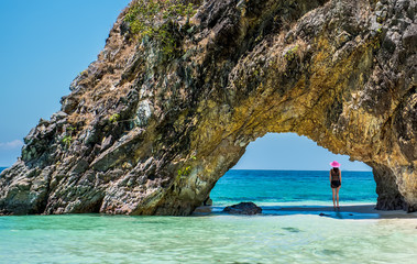 Beautiful girl in swimsuit at Lover's Gate on the Khai island, Satun, Thailand.