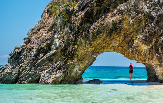 Beautiful girl in swimsuit at Lover's Gate on the Khai island, Satun, Thailand.