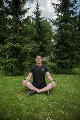 Naklejka na ściany i meble young man enjoying in yoga outdoors 