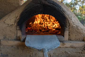 Pizzas cooking in stone and cob pizza oven