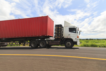 Red truck on the highway under the blue sky