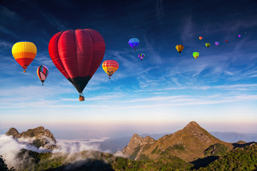 Fototapeta na wymiar Aerial view colorful hot air balloons flying over with the mist at Doi Luang Chiang Dao with morning mist in Chiang Mai, Thailand..