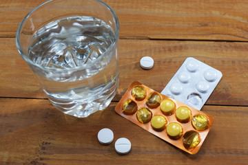 a glass of water and tablets on the table, a doctor's discharge