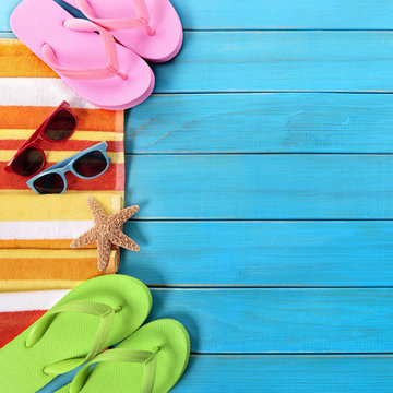Summer beach objects border, sunglasses, flip flops, copy space
