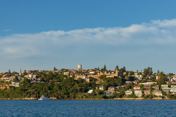 Suburb cityscape with waterfront property and bay of water